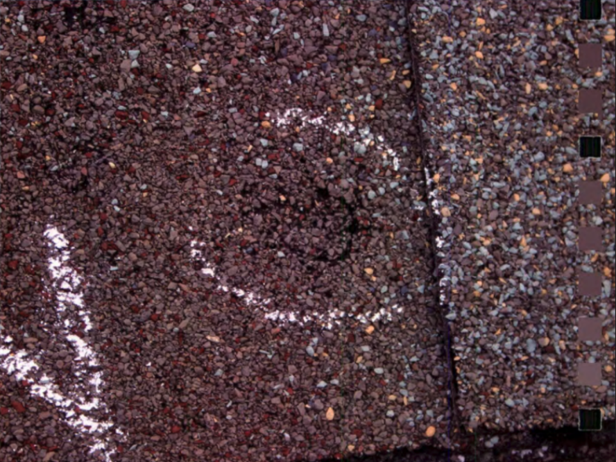 Circular impression in shingles from hail damage